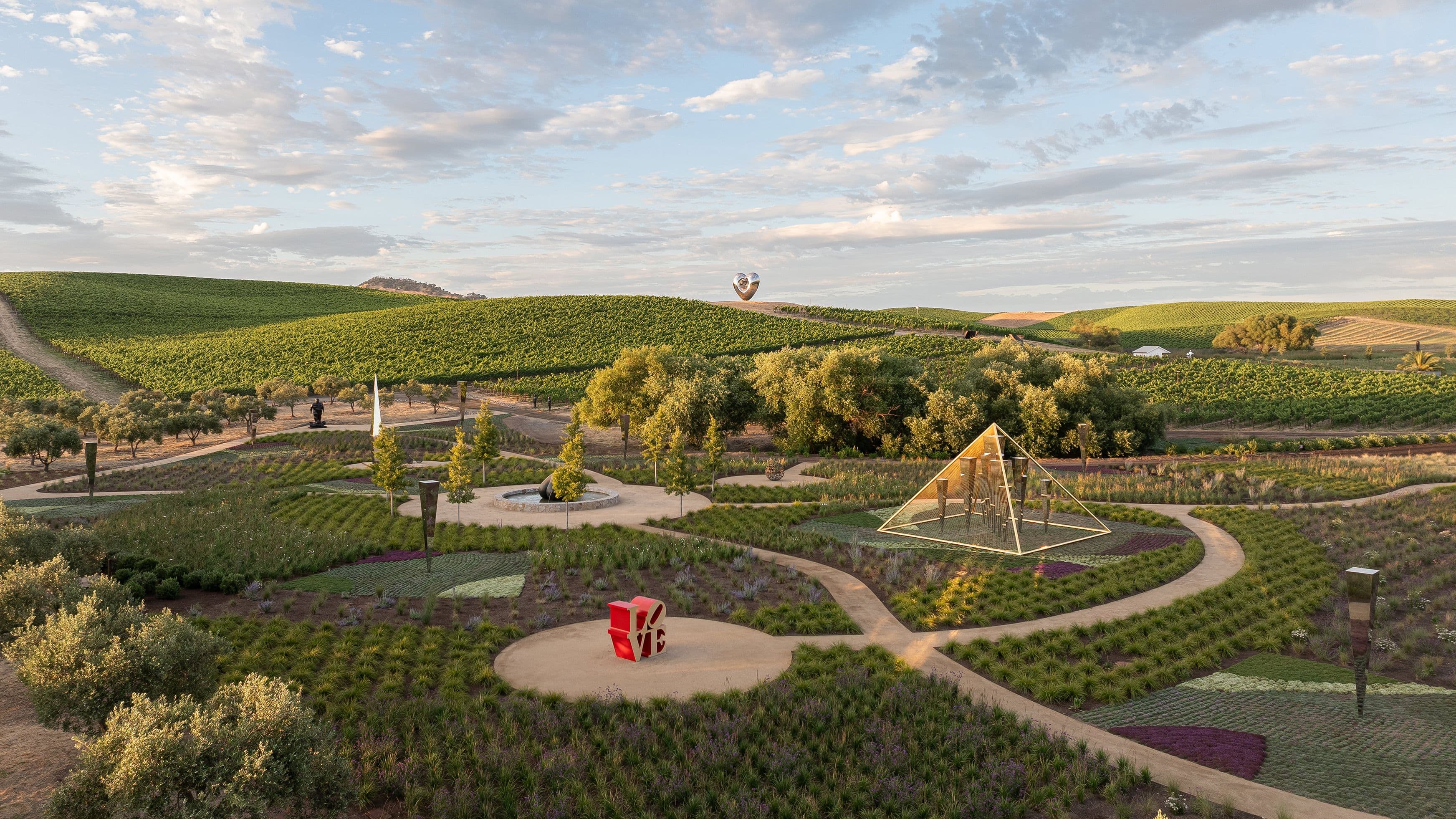 A landscaped sensory garden with grasses, shrubs, and sculptural stones at the Donum Estate